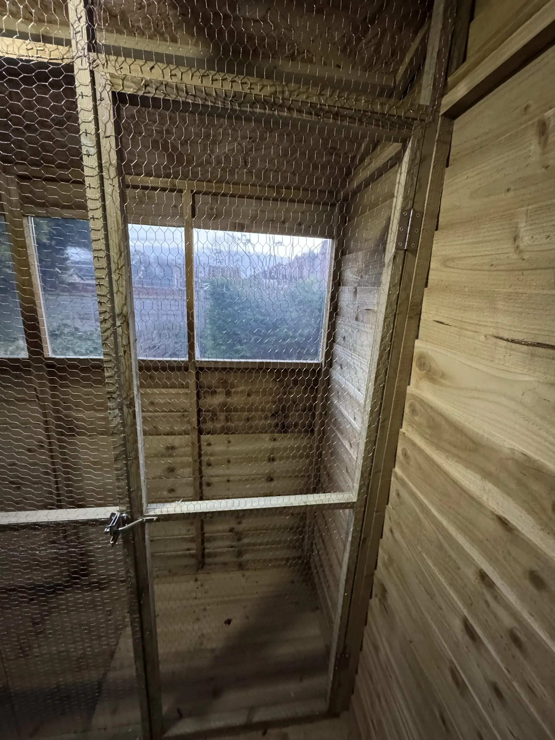 Mesh and timber panelling of the completed bird aviary
