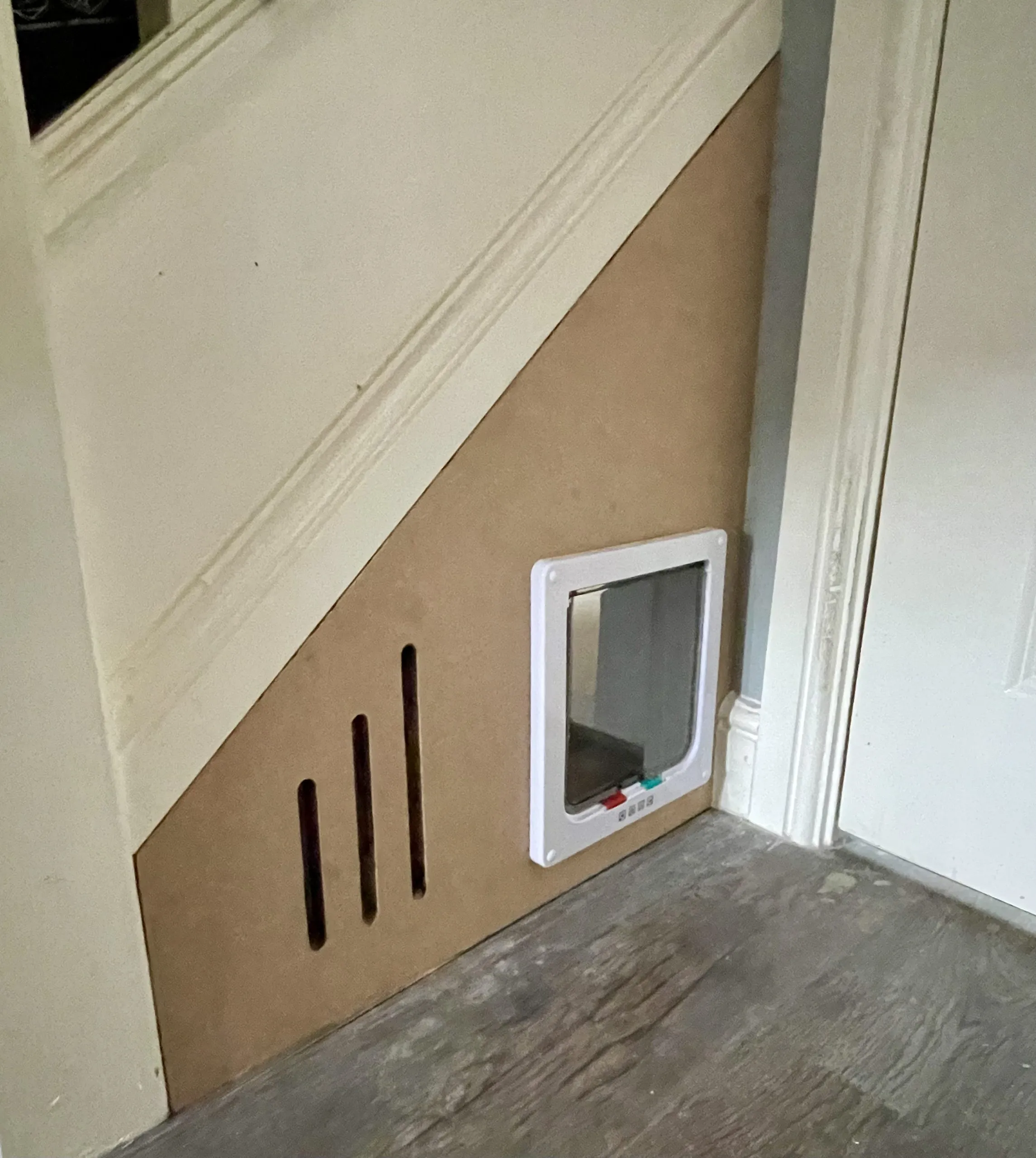 Access hatch built into a partition wall during a room conversion